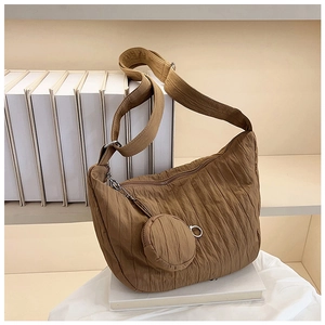 Detail of brown pleated dumpling bag with matching round mini coin purse attachment