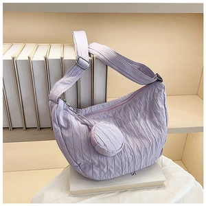 Detail of lilac crescent nylon bag featuring pleated quilted texture and small coin pouch