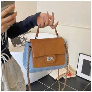 Detailed view of vintage quilted leather flap and silver twist lock on chain bag