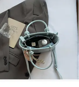 Interior view of mint green leather bucket bag with large capacity for cosmetics