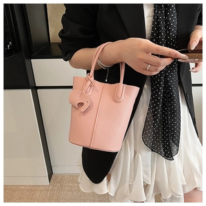 Pink lychee grain leather bucket bag with cute elephant charm and stitch detail