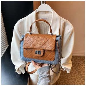 Detail showing mixed denim fabric with brown quilted leather flap and metal turn-lock closure