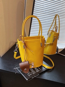 Vintage yellow bucket bag with top handle and adjustable shoulder strap for women