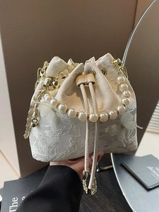 Elegant off-white lace bucket bag with pearl handle and 3D floral butterfly detail