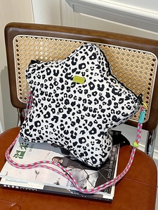 Star-shaped leopard print crossbody bag with colorful braided rope strap and green logo
