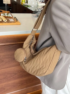 Khaki crescent shoulder bag in pleated nylon with a small round pouch for daily commuting