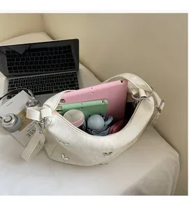 Interior view showing the large capacity of the beige tote bag with a butterfly rivet