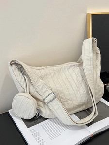 Chic beige dumpling shoulder bag with pleated texture and adjustable strap plus mini pouch