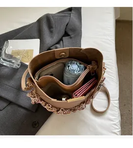 Top view of beige bucket bag showing spacious interior with zipper and daily essentials