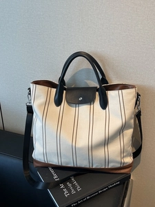Large capacity striped canvas tote bag with leather accents and wide crossbody strap