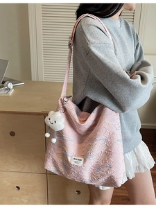 Pink quilted tote bag with colorful embroidery and white cloud plush charm for women