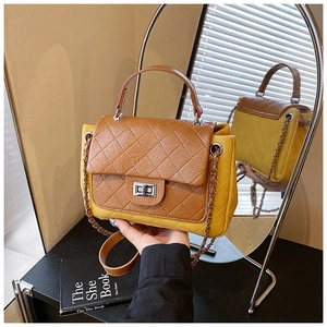 Detail of quilted two-tone crossbody bag with silver twist lock and chain strap