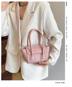 Detail shot of pink lychee pattern texture on a stylish bucket bag with silver hardware