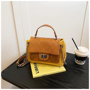 Detail of quilted leather crossbody bag with chain strap and silver twist lock