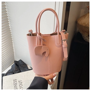 Pink lychee grain leather bucket bag with cute elephant pendant and silver hardware details