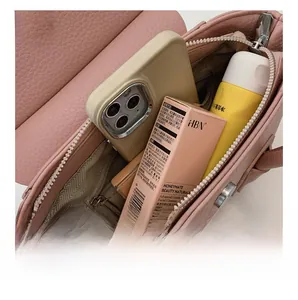 Pink lychee leather bag interior view with zipper pocket and magnetic snap buckle