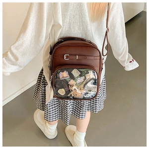 Detail view of brown leather ITA bag with transparent PVC display for cute cat stickers
