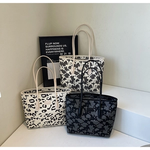 Detailed set of leopard and cow print tote bags on a display for fashion inspiration