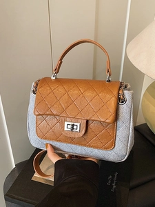 Quilted two-tone chain crossbody bag with brown flap and grey body in a modern studio setting