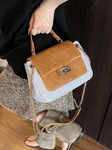 Quilted brown leather and blue fabric crossbody chain bag shown on a model