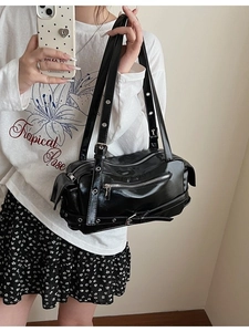 Chic black faux leather pillow bag with silver eyelets and Y2K streetwear styling