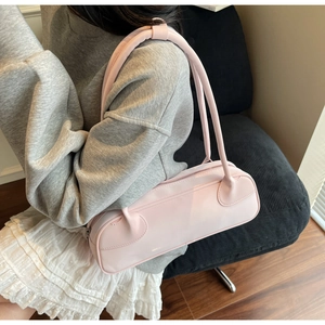 Light pink faux leather shoulder bag styled with grey hoodie and white pleated skirt