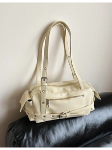 Chic off-white minimalist pillow bag with multi-pocket design and silver punk hardware
