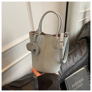 Detail of light blue bucket bag with pebble leather and cute elephant charm