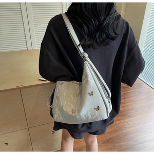 Silver crescent hobo bag featuring 3D metal butterfly charms and wrinkled texture