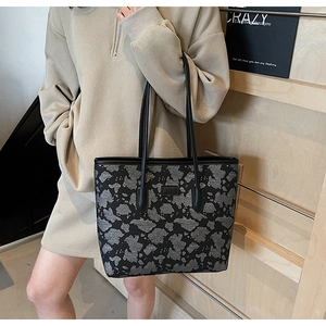 Fashionable black and grey camo tote bag detail with long shoulder straps for daily use