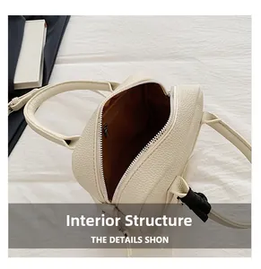 Top view of cream Boston bag interior showing brown lining and metal zipper pocket