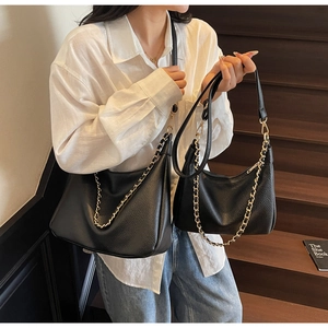 Detailed comparison of large and small black lychee leather hobo bags with gold chains