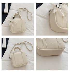 Close-up of cream white pebble grain mini bag with silk flower charm and fashion embossing
