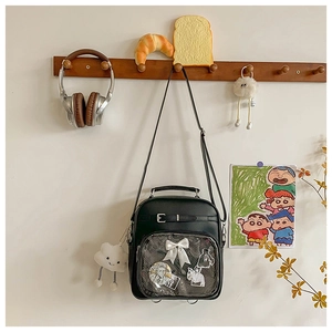 Detail of black ita bag featuring a large clear window for anime badge display