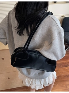 Minimalist black glossy shoulder bag with a sleek patent leather finish for daily wear