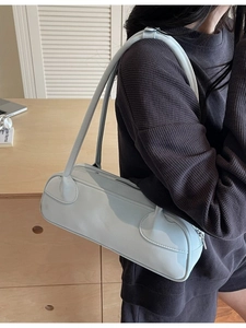 Minimalist light blue PU leather baguette bag with dual shoulder straps shown on a model