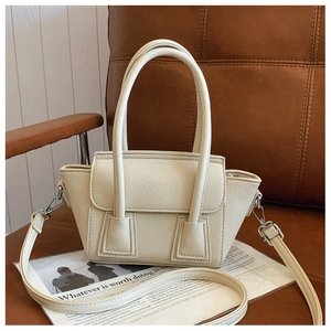 Detailed macro view of the cream lychee grain leather texture and silver hardware