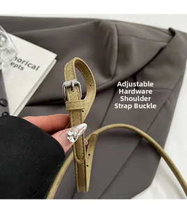 Detail of adjustable khaki PU leather shoulder strap with polished silver metal buckle