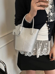 Silver leather bucket handbag with elephant charm and minimalist stitching detail