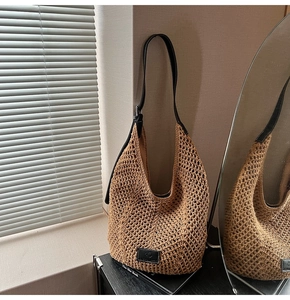 Detailed macro view of hollow crochet woven shoulder bag with black leather strap