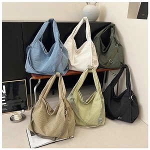 Detail shot of multi-color large canvas hobo bags with textured checkered fabric pattern