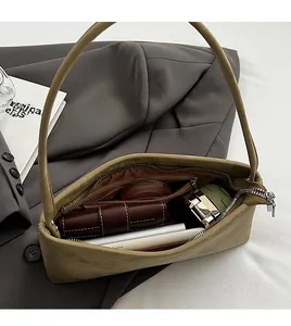 Spacious interior of khaki underarm bag showing room for smartphone and cosmetics