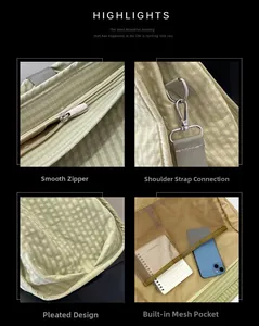 Detail view of green checkered canvas bag with smooth zipper and reinforced metal buckles
