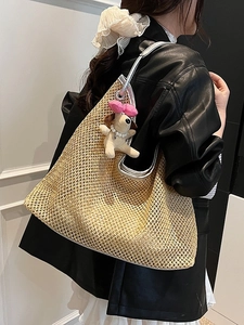 Large beige woven straw tote bag with silver leather trim and cute puppy charm accessory