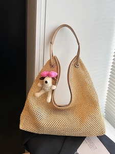 Straw hollow shoulder bag with brown leather trim and a cute puppy plush charm