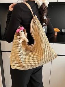 Vintage khaki woven straw tote bag with leather straps and a pink puppy charm for summer