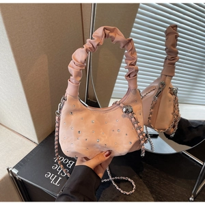 Detailed view of pink rhinestone dumpling bag with ruched handle and silver chain strap