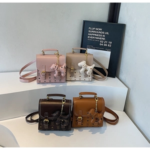 Detail of four colorful mini backpacks with flap buckle closure and cartoon patterns