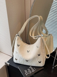 Chic beige shoulder bag with silver butterfly charms and pleated fabric texture