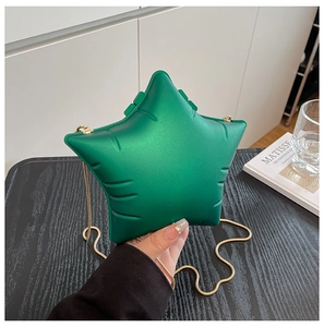 Macro shot of green star-shaped chain bag with balloon texture and gold metal strap